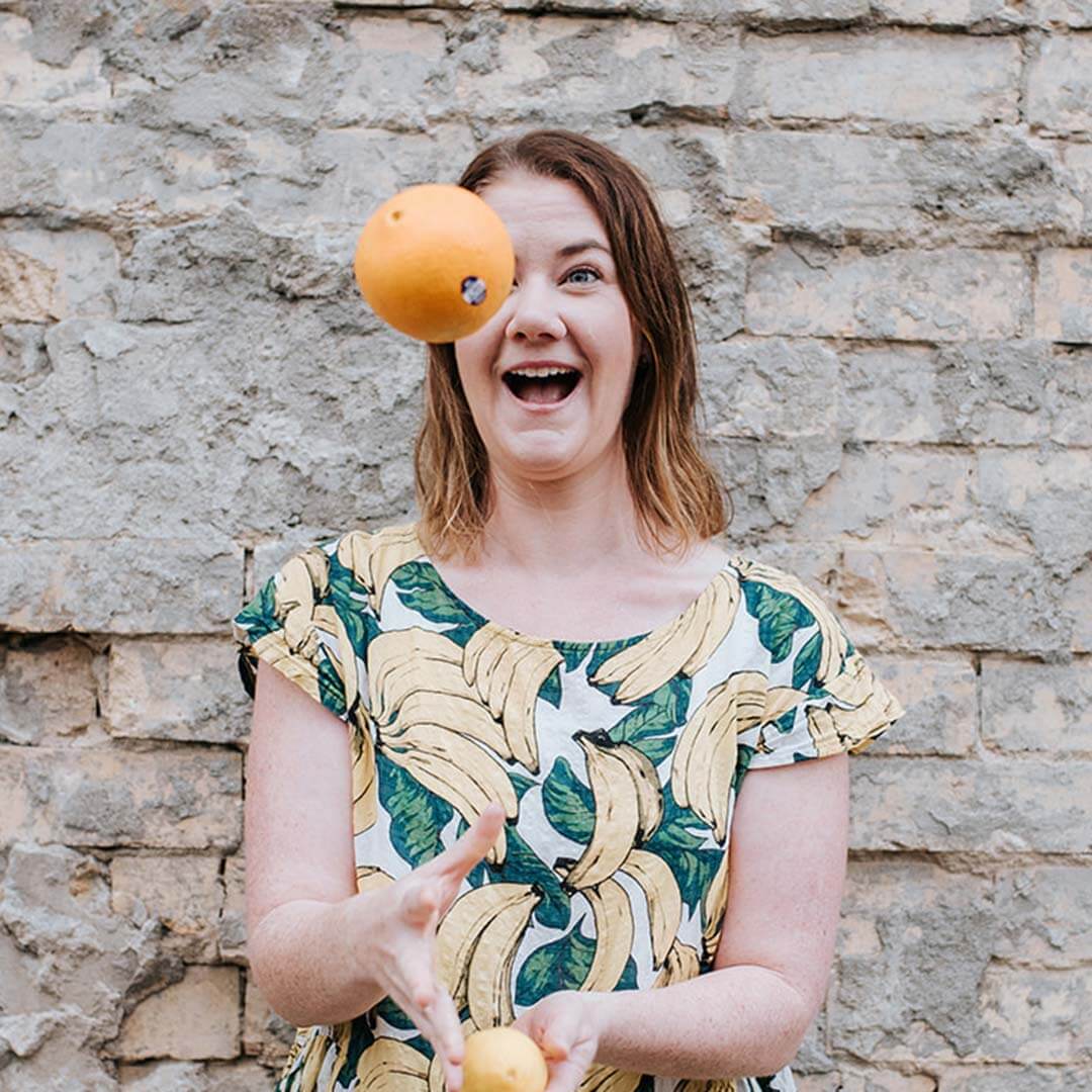 Mel Finlay, juggling oranges and laughing.