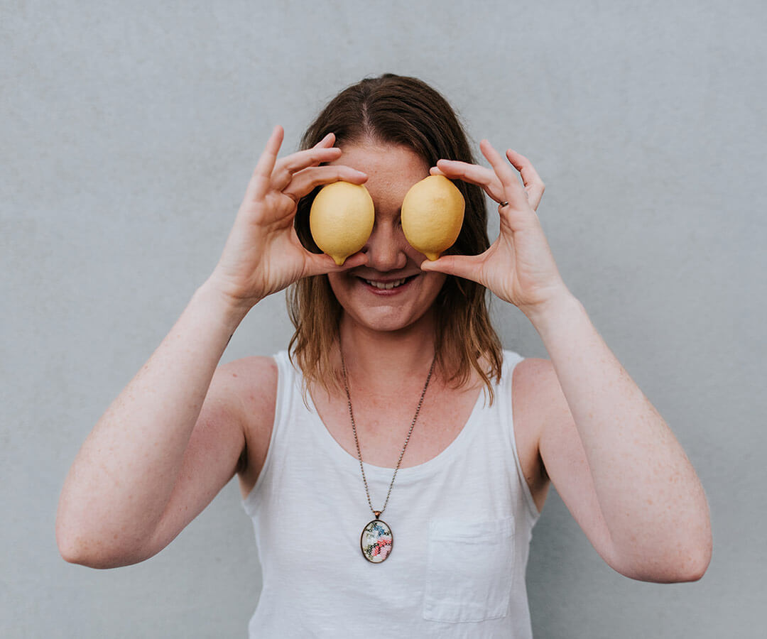 Melbourne nutritionist Mel Finlay holding lemons over her eyes.