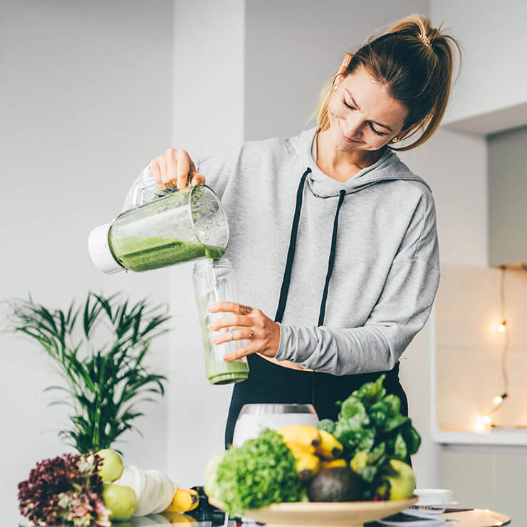 Woman making healthy nutritious smoothie