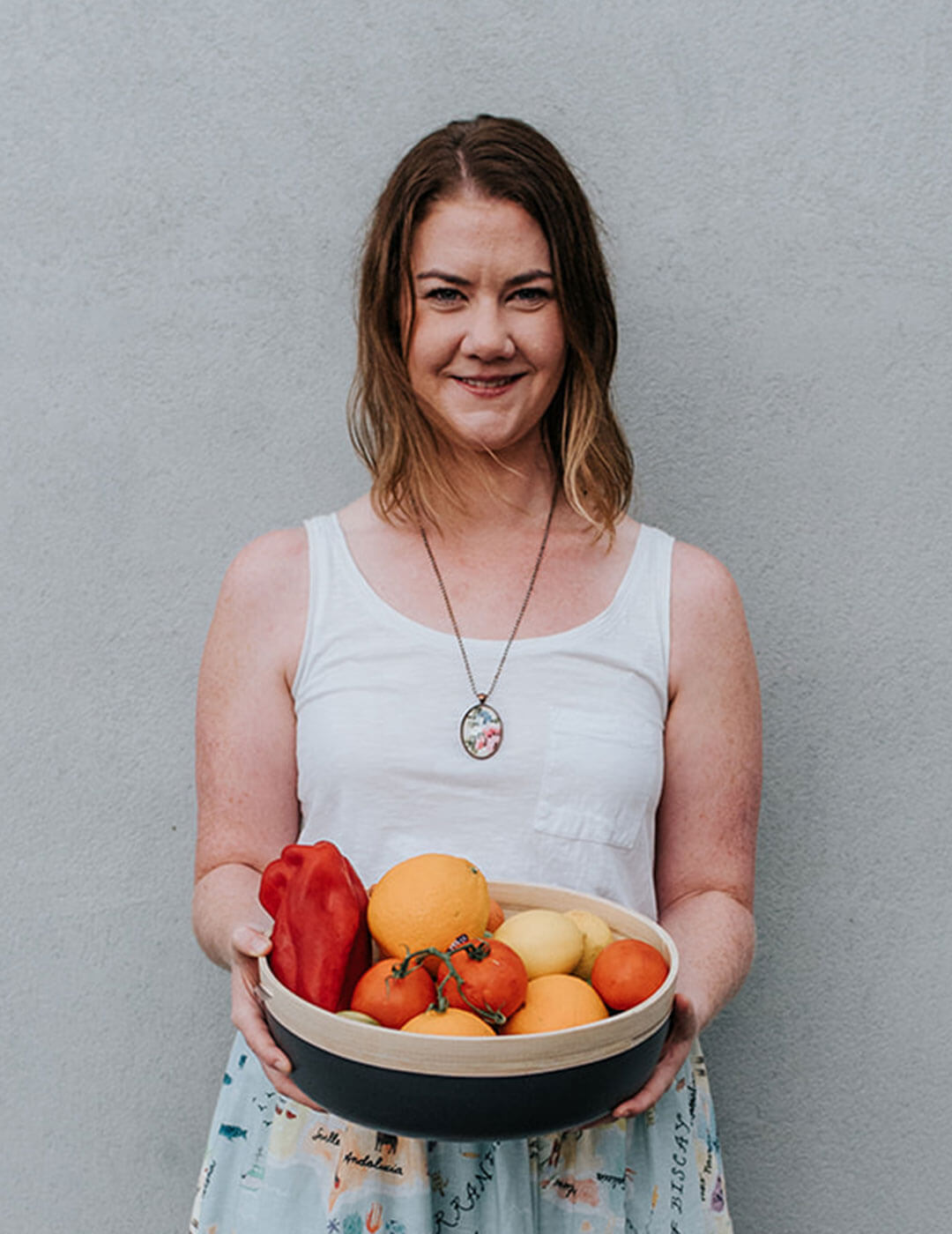 Women's health specialist, Melissa Finlay, holding a bowl of fruit.